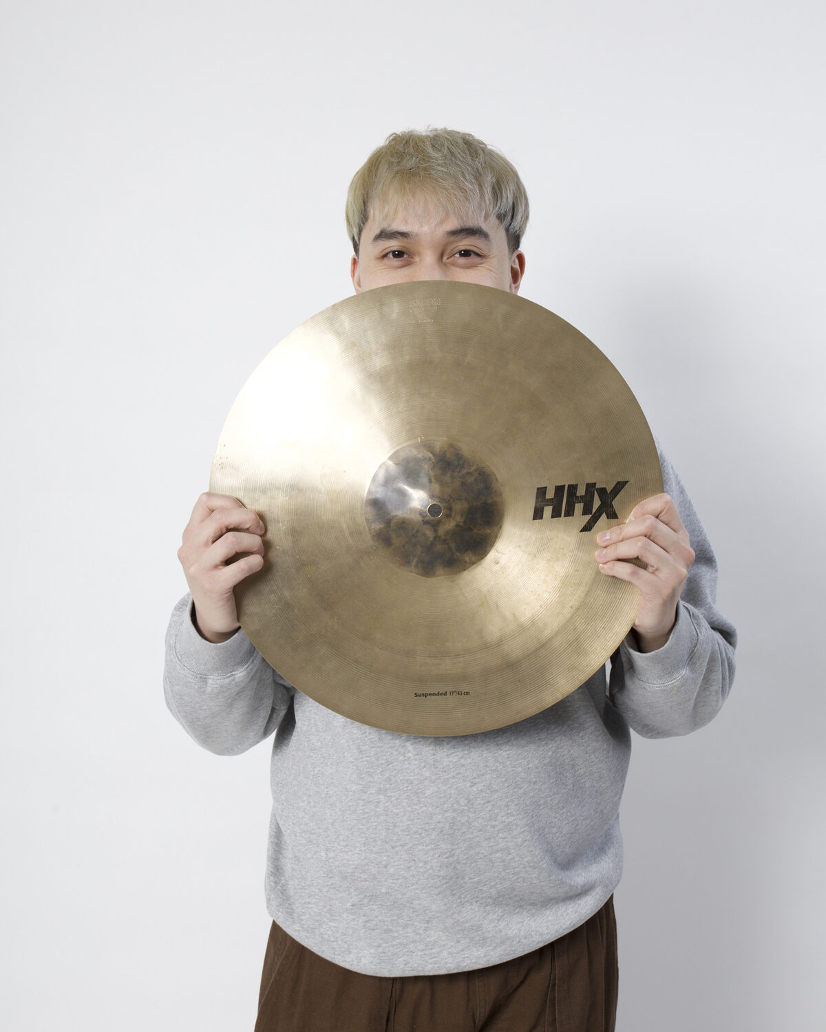Portrait of Matthew Noah Reyes holding a cymbal
